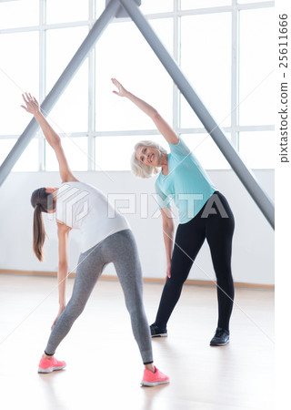 Positive enthusiastic woman doing bending Positive enthusiastic woman doing bending 25611666