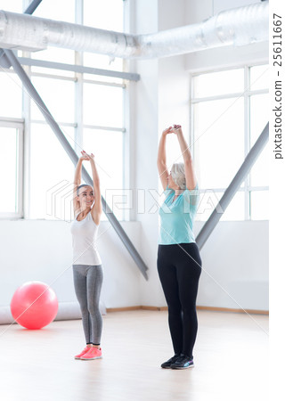 Skillful experienced coach showing the physical Skillful experienced coach showing the physical 25611667
