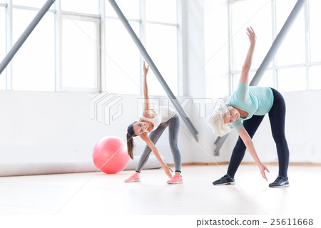 Active cheerful women exercising in a fitness club Active cheerful women exercising in a fitness club 25611668