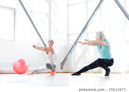 Good looking joyful women having aerobics classes Good looking joyful women having aerobics classes 25611671