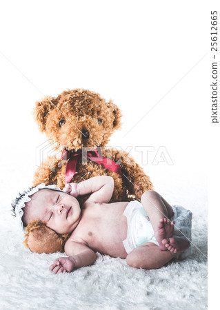 Newborn baby and bear's stuffed toy 25612665