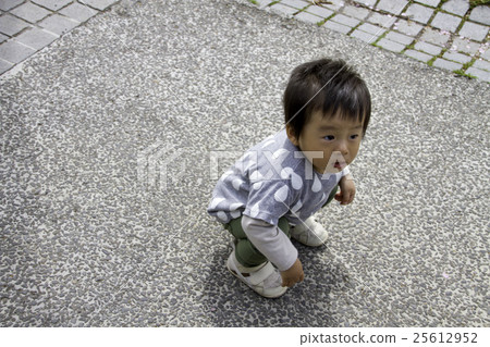 A boy playing in a park 25612952