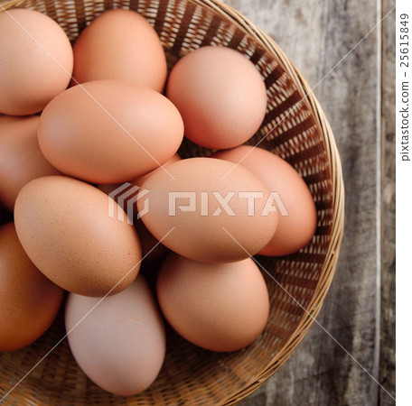Easter egg in a basket on wodden table 25615849