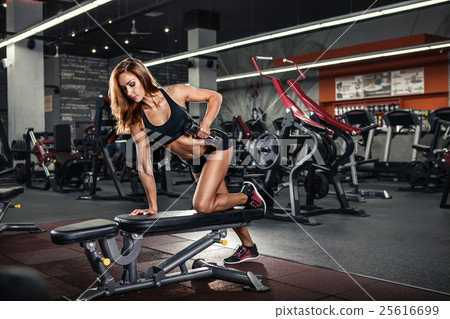 Girl pumping up muscles with dumbbells 25616699