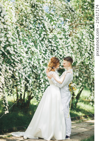 Happy wedding couple walking in a botanical park Happy wedding couple walking in a botanical park 25617174