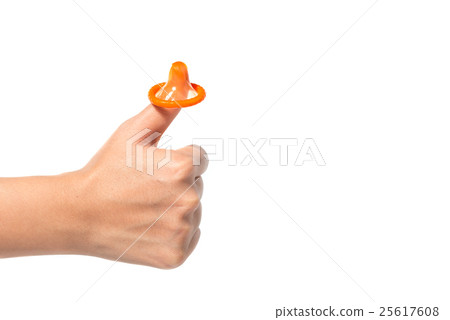 Yellow condom on female hand Yellow condom on female hand 25617608
