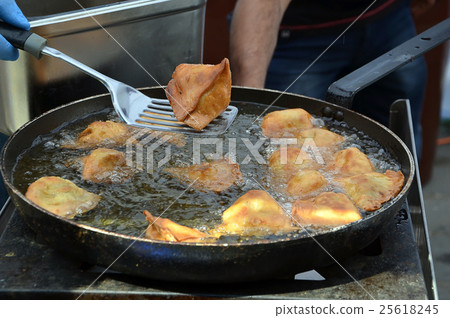 asian fryied meat filled pasties on the pan 25618245