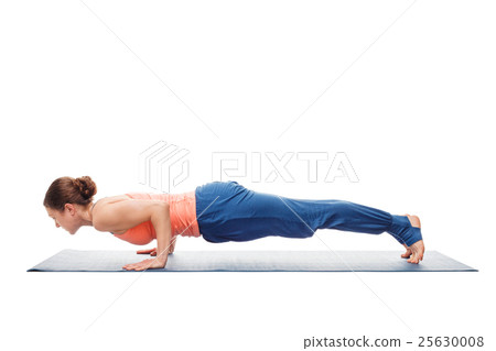 Woman doing Ashtanga Vinyasa Yoga asana Chaturanga Woman doing Ashtanga Vinyasa Yoga asana Chaturanga 25630008
