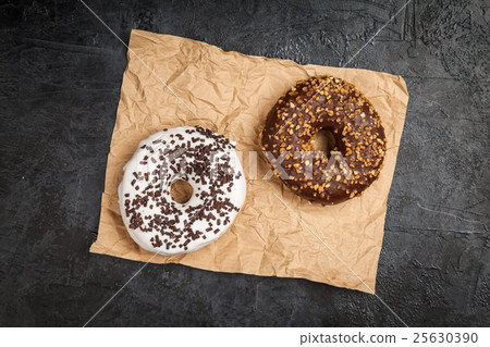 Tasty donuts on dark background 25630390