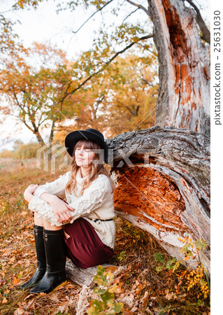 beautiful girl in the autumn forest. young with 25631030