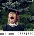Girl in school uniform wearing graduation cap 25631380