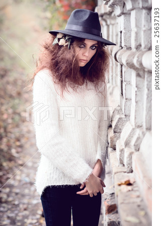 Beautiful girl on brick wall background Beautiful girl on brick wall background 25637193