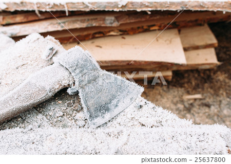 Big axe outside near bunch of firewood 25637800