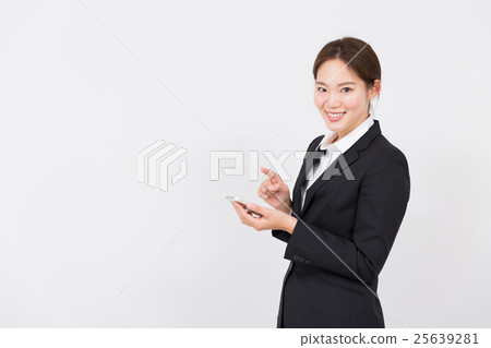 A woman using a mobile phone A woman using a mobile phone 25639281