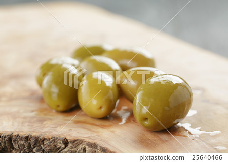 green huge olives on wood table green huge olives on wood table 25640466