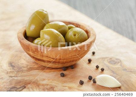 green huge olives on wood table green huge olives on wood table 25640469