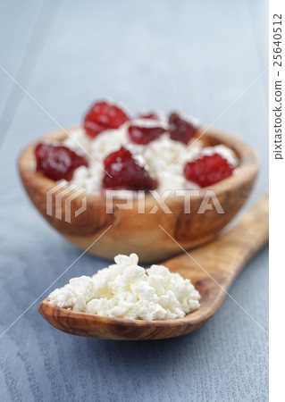 cottage cheese with preserved strawberry on blue table cottage cheese with preserved strawberry on blue table 25640512
