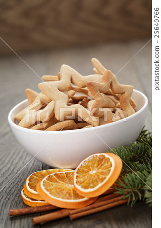 classic star cookies in white bowl with christmas decorations 25640766