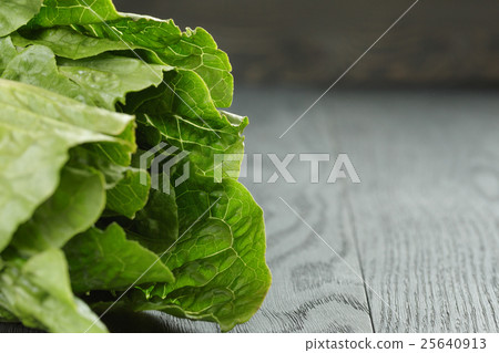 fresh romain green salad on wood table fresh romain green salad on wood table 25640913