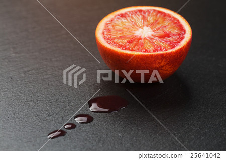 red sicilian orange sliced on slate board with 25641042