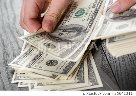 young female hands count dollar bills on table young female hands count dollar bills on table 25641311