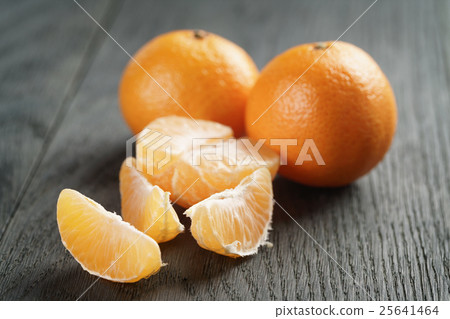 ripe tangerines peeled on wood table 25641464