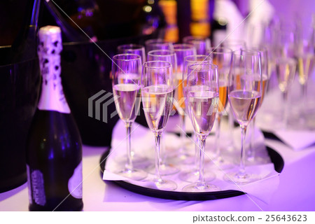 Lots of wine glasses during some festive event Lots of wine glasses during some festive event 25643623
