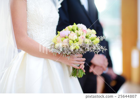 Bride holding a beautiful wedding bouquet 25644807