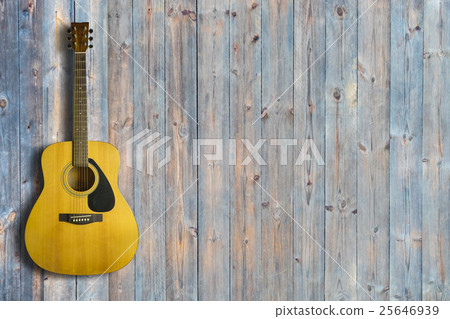 Acoustic guitar on wooden background texture 25646939
