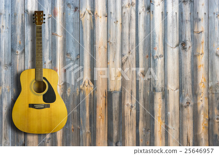 Acoustic guitar on wooden background texture Acoustic guitar on wooden background texture 25646957
