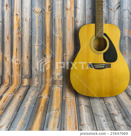 Acoustic guitar on wooden background texture 25647069