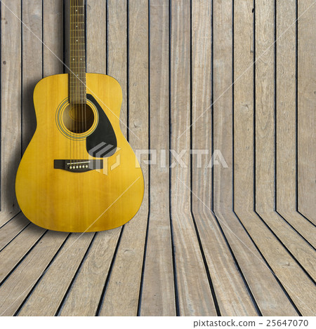 Acoustic guitar on wooden background texture Acoustic guitar on wooden background texture 25647070