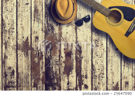 Acoustic guitar with hat and sunglasses on wooden Acoustic guitar with hat and sunglasses on wooden 25647090