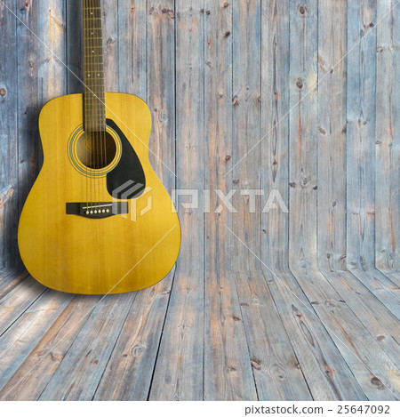 Acoustic guitar on wooden background texture Acoustic guitar on wooden background texture 25647092