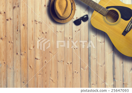 Acoustic guitar with hat and sunglasses on wooden Acoustic guitar with hat and sunglasses on wooden 25647093