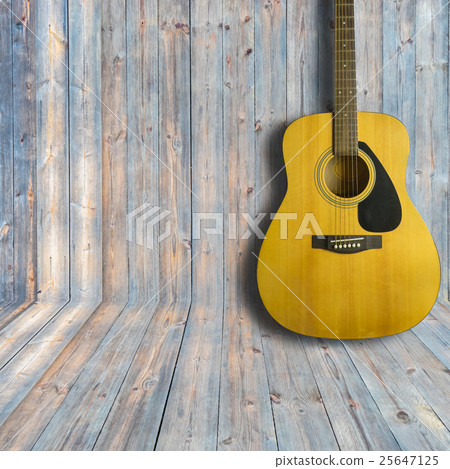Acoustic guitar on wooden background texture 25647125