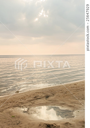 Puddle in sand on seashore Puddle in sand on seashore 25647929