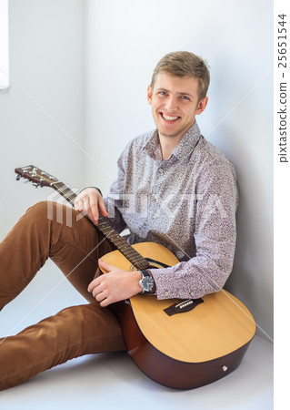 Portrait of handsome smiling man with guitar 25651544