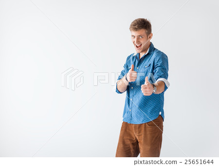 Portrait of happy smiling handsome man giving thumbs up sign 25651644