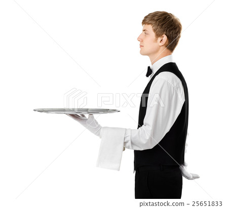 Profile of young handsome waiter holding empty tray with copy sp Profile of young handsome waiter holding empty tray with copy sp 25651833