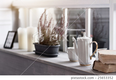Grey wooden windowsill tightly decorated  25653352