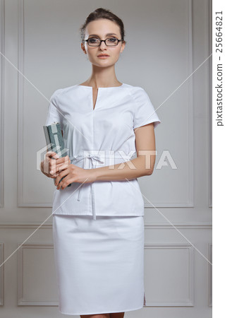 Beautiful female doctor in white clothes. Portrait of attractive Beautiful female doctor in white clothes. Portrait of attractive 25664821