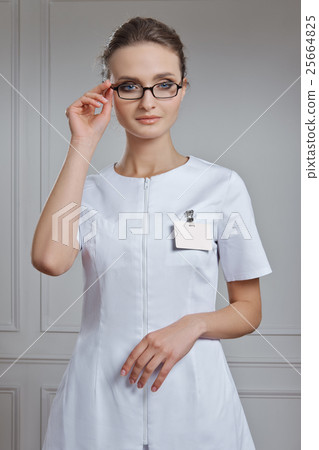 Beautiful female doctor in white clothes. Portrait of attractive 25664825