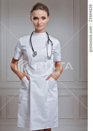 Beautiful female doctor in white clothes. Portrait of attractive 25664826