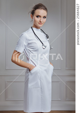 Beautiful female doctor in white clothes. Portrait of attractive 25664827