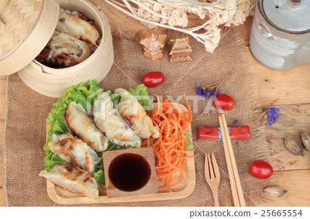 Fried gyoza and sauces - traditional Japanese food Fried gyoza and sauces - traditional Japanese food 25665554