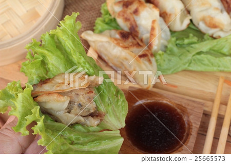 Fried gyoza and sauces - traditional Japanese food Fried gyoza and sauces - traditional Japanese food 25665573