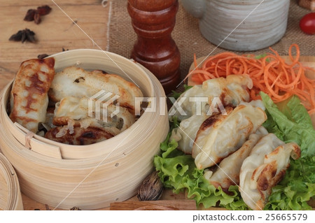 Fried gyoza and sauces - traditional Japanese food Fried gyoza and sauces - traditional Japanese food 25665579