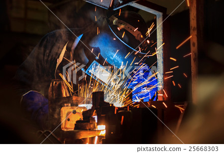 Welder in action welding metal in factory Welder in action welding metal in factory 25668303