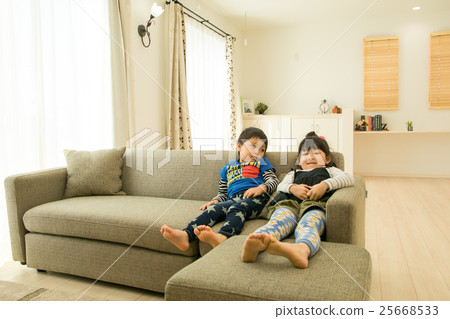 Children relaxing in the living room Children relaxing in the living room 25668533